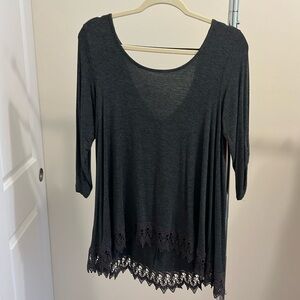 3/4 length shirt with decorative lace at bottom.